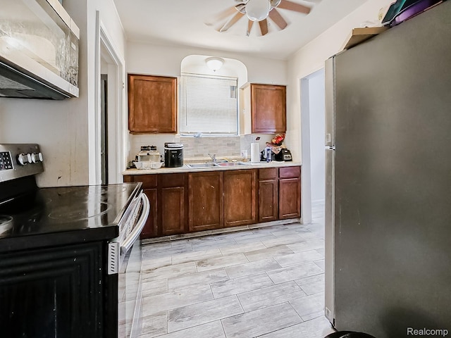 15882 Appoline St, Detroit, MI 48227 - kitchen featuring freestanding refrigerator, electric range oven, a ceiling fan, light countertops, and tasteful backsplash