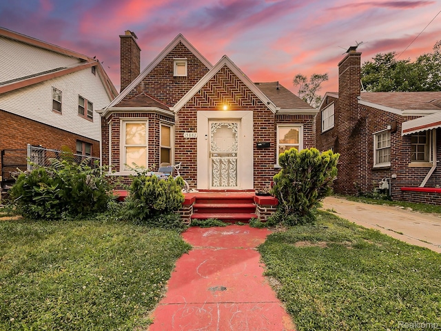 15882 Appoline St, Detroit, MI 48227 - view of front facade featuring brick siding, a chimney, and a yard