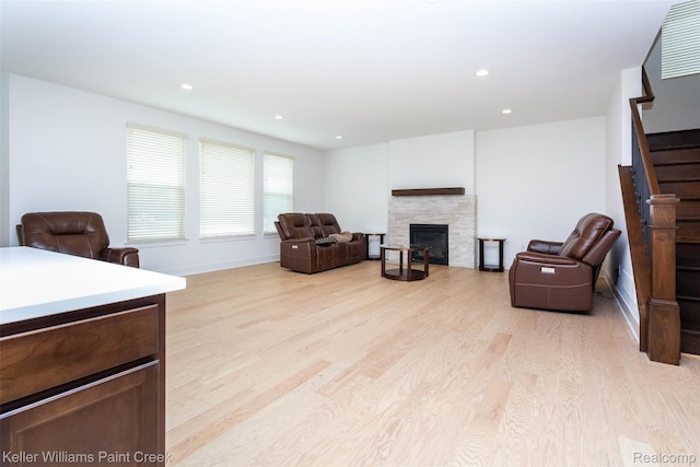 24738 Callaway Dr, Macomb, MI 48042 - living area featuring light wood-style floors, stairway, a fireplace, and recessed lighting