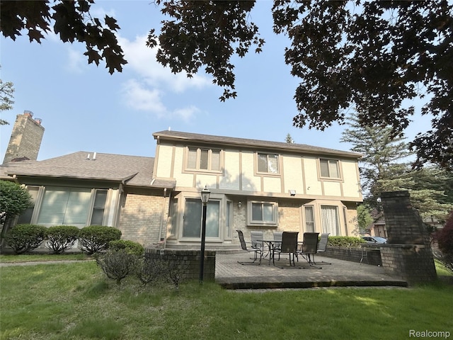4567 Odette Ct, Troy, MI 48098 - back of property with a lawn, a patio area, a chimney, and brick siding