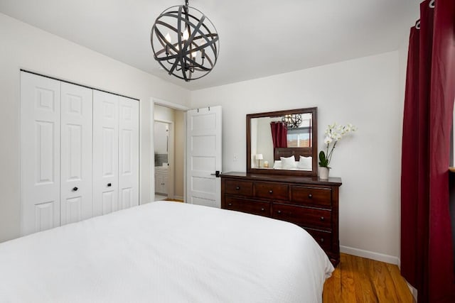 2534 Pamela Ave, Ann Arbor, MI 48103 - bedroom with a chandelier, baseboards, light wood-style floors, and a closet
