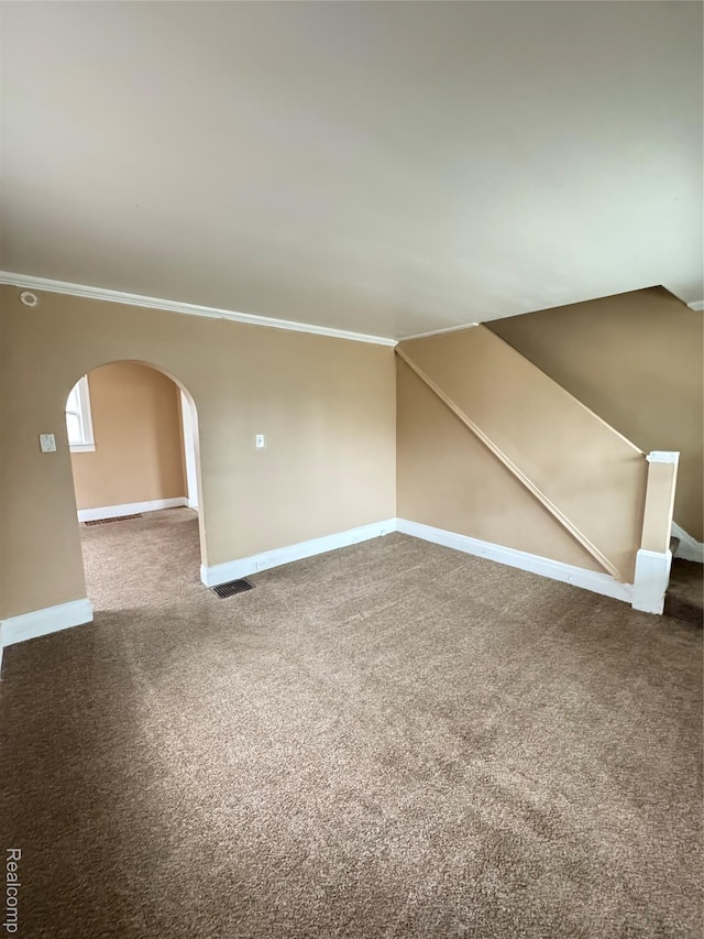 244 Nelson St, Pontiac, MI 48342 - spare room featuring ornamental molding, arched walkways, baseboards, carpet, and stairway