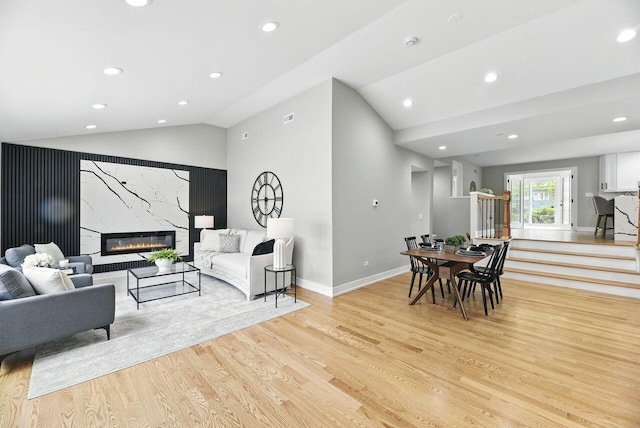 340 N Berrien St, New Buffalo, MI 49117 - living room with vaulted ceiling, light wood-style floors, recessed lighting, a premium fireplace, and baseboards