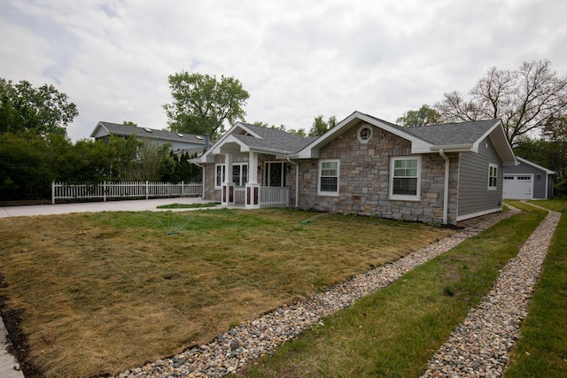 340 N Berrien St, New Buffalo, MI 49117 - ranch-style house with stone siding, a detached garage, and a shingled roof