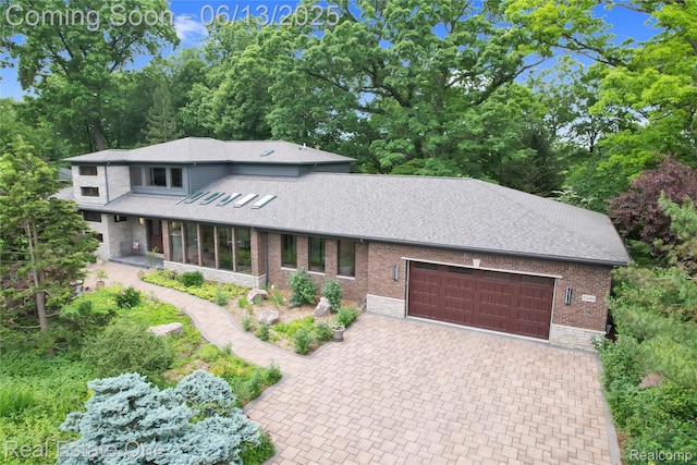 15349 Lakeside St, Plymouth, MI 48170 - view of front of house featuring an attached garage, roof with shingles, decorative driveway, and brick siding