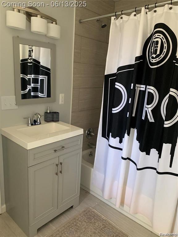 8100 Toepfer Rd, Warren, MI 48089 - bathroom featuring vanity and shower / bathtub combination with curtain