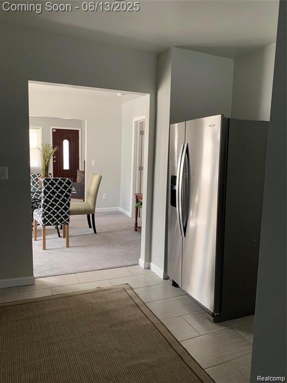 8100 Toepfer Rd, Warren, MI 48089 - kitchen featuring stainless steel fridge, light carpet, and light tile patterned flooring