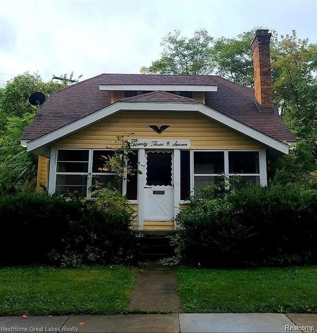 2307 Monteith St, Flint, MI 48504 - view of front facade with a shingled roof, a chimney, and entry steps