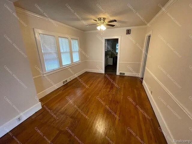 2307 Monteith St, Flint, MI 48504 - empty room featuring crown molding, wood finished floors, baseboards, and a ceiling fan