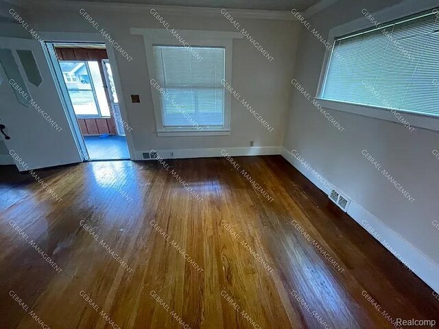 2307 Monteith St, Flint, MI 48504 - spare room featuring wood finished floors and baseboards