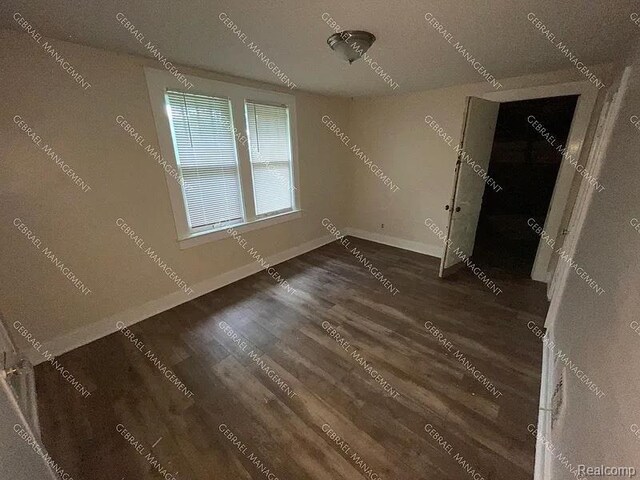2307 Monteith St, Flint, MI 48504 - unfurnished bedroom with wood finished floors and baseboards