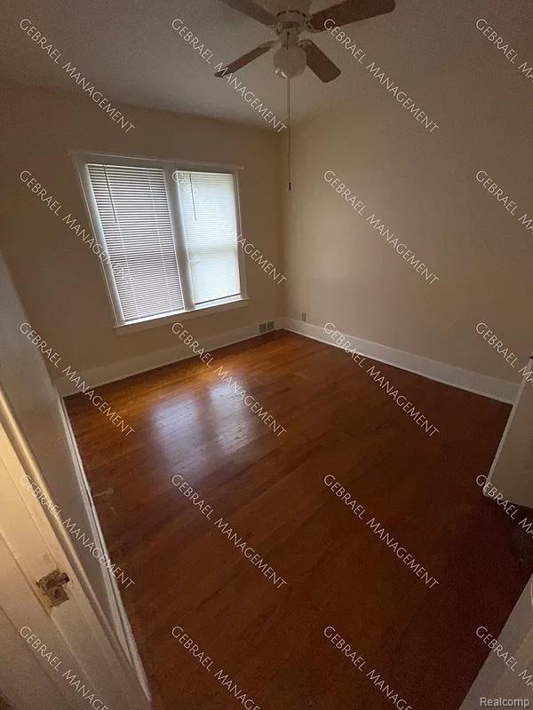 2307 Monteith St, Flint, MI 48504 - unfurnished room featuring wood finished floors, a ceiling fan, and baseboards