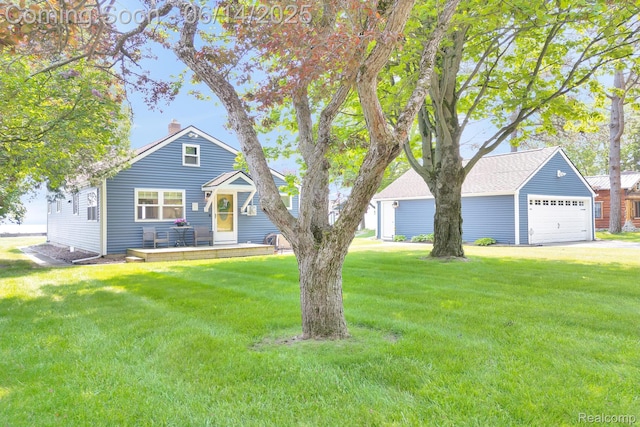 2968 Wolverine Rd, East Tawas, MI 48730 - view of front facade with a chimney, a front yard, and a detached garage
