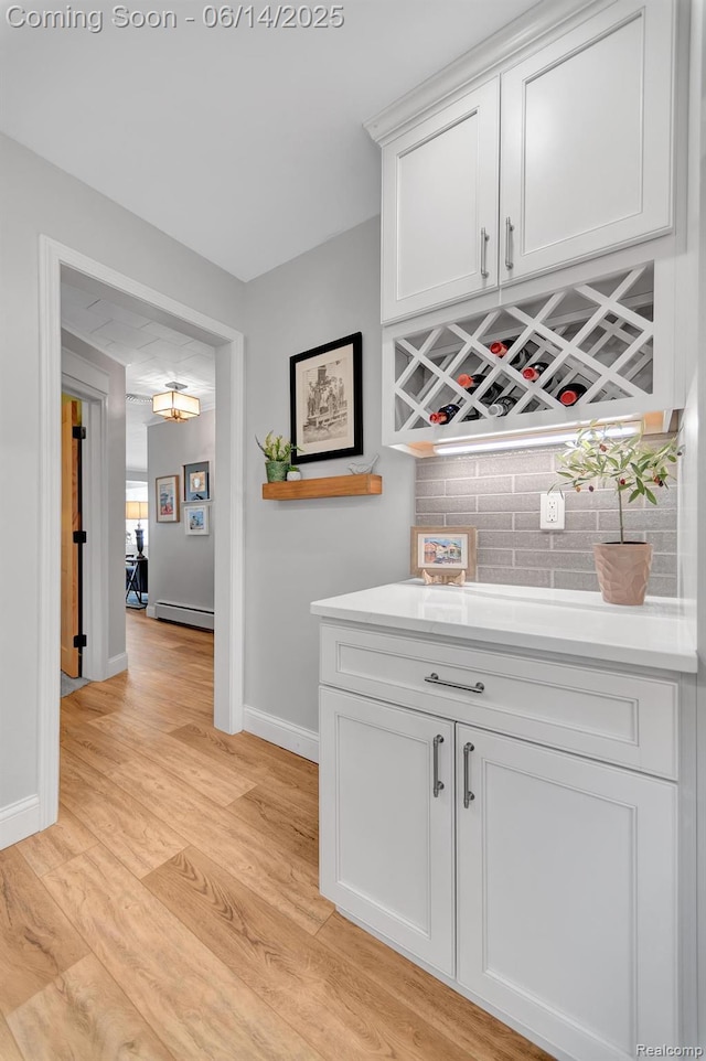 2968 Wolverine Rd, East Tawas, MI 48730 - indoor dry bar with light wood-style floors and baseboard heating