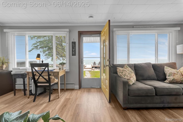 2968 Wolverine Rd, East Tawas, MI 48730 - living room featuring crown molding, light wood-type flooring, and an office area
