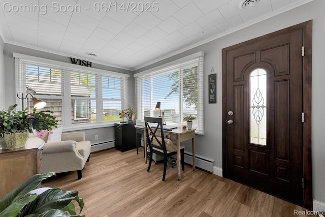 2968 Wolverine Rd, East Tawas, MI 48730 - entrance foyer with ornamental molding, plenty of natural light, light wood-type flooring, and baseboard heating