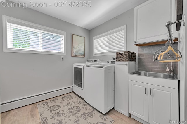 2968 Wolverine Rd, East Tawas, MI 48730 - laundry area featuring a baseboard heating unit, cabinet space, and washing machine and dryer