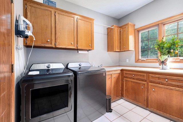 6526 Ada Dr SE, Ada, MI 49301 - laundry room with cabinet space, separate washer and dryer, and light tile patterned floors