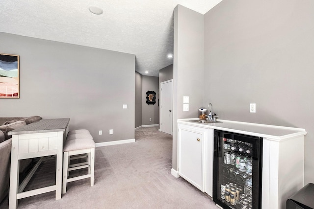6526 Ada Dr SE, Ada, MI 49301 - indoor wet bar featuring beverage cooler, light colored carpet, and baseboards