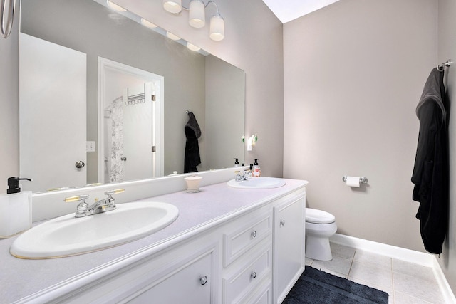 6526 Ada Dr SE, Ada, MI 49301 - full bathroom featuring double vanity, tile patterned floors, toilet, and baseboards