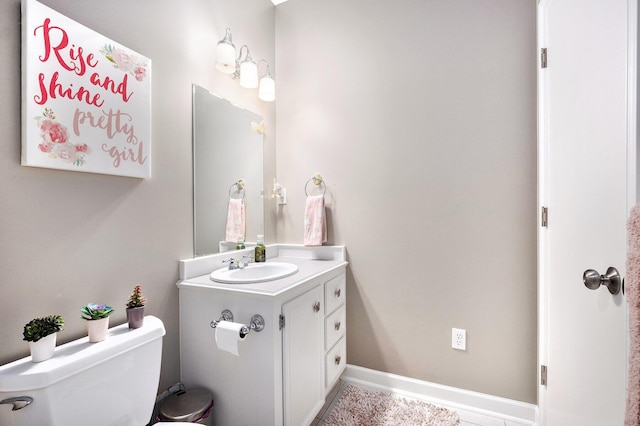6526 Ada Dr SE, Ada, MI 49301 - bathroom featuring toilet, vanity, tile patterned floors, and baseboards