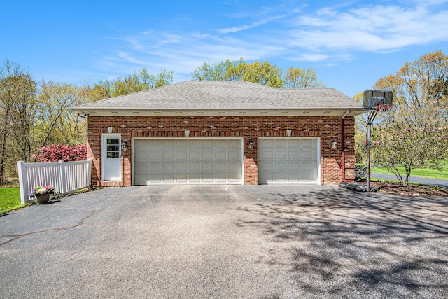 6526 Ada Dr SE, Ada, MI 49301 - view of side of property featuring asphalt driveway, roof with shingles, brick siding, and a garage