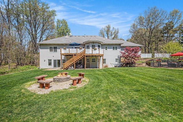 6526 Ada Dr SE, Ada, MI 49301 - rear view of property featuring stairs, a fire pit, and a wooden deck