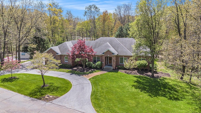 6526 Ada Dr SE, Ada, MI 49301 - view of front of house featuring brick siding and a front lawn