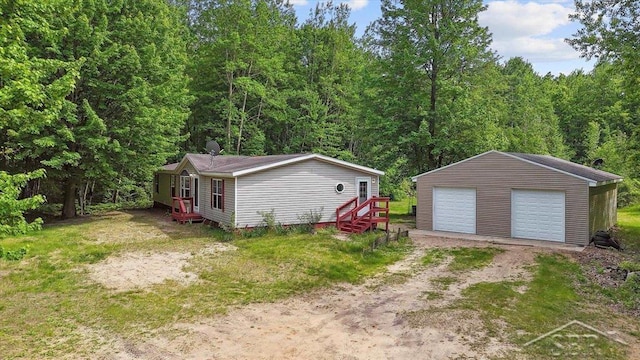 3251 W Dana Rd, Coleman, MI 48618 - detached garage with a view of trees