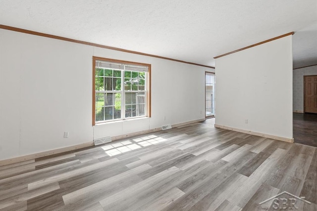 3251 W Dana Rd, Coleman, MI 48618 - empty room featuring ornamental molding, wood finished floors, a textured ceiling, and baseboards