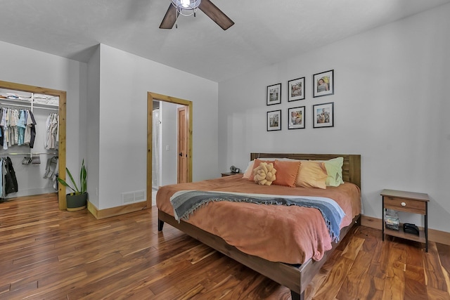 9725 Green Briar Rd, Lake Ann, MI 49650 - bedroom with wood finished floors, a closet, a ceiling fan, and a spacious closet