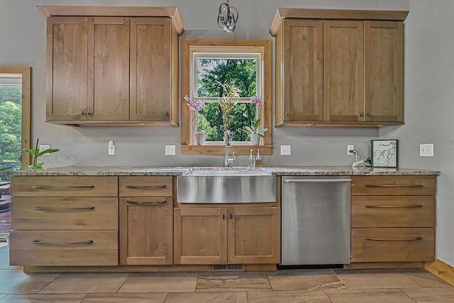 9725 Green Briar Rd, Lake Ann, MI 49650 - kitchen featuring stainless steel dishwasher, light stone counters, and brown cabinetry