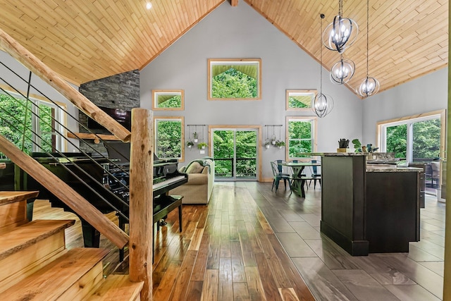 9725 Green Briar Rd, Lake Ann, MI 49650 - living area featuring high vaulted ceiling, stairway, wood-type flooring, wooden ceiling, and a chandelier