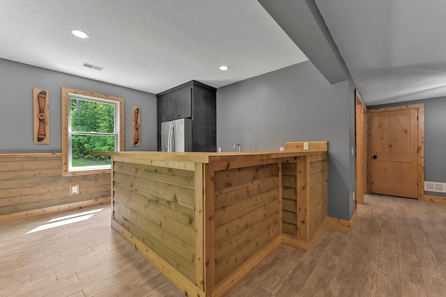 9725 Green Briar Rd, Lake Ann, MI 49650 - bar area featuring stainless steel fridge, light wood-style floors, and recessed lighting