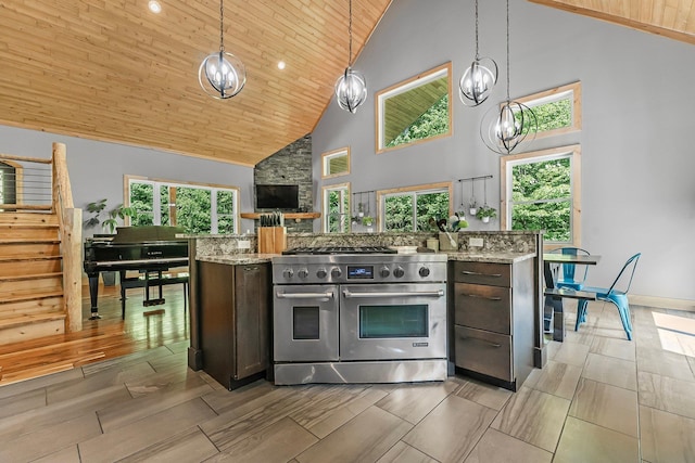 9725 Green Briar Rd, Lake Ann, MI 49650 - kitchen featuring range with two ovens, high vaulted ceiling, wooden ceiling, dark brown cabinets, and light stone countertops