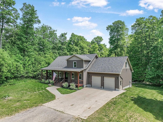9725 Green Briar Rd, Lake Ann, MI 49650 - view of front facade with covered porch, a garage, a front lawn, and driveway