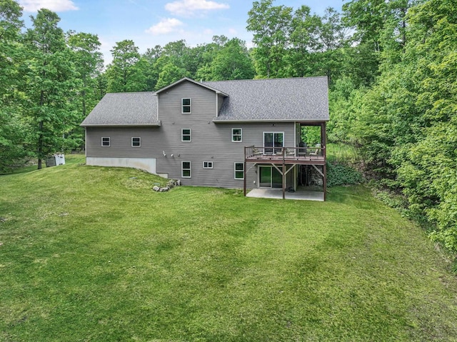 9725 Green Briar Rd, Lake Ann, MI 49650 - back of property with a patio area, a deck, roof with shingles, and a yard