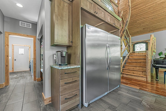 9725 Green Briar Rd, Lake Ann, MI 49650 - kitchen featuring freestanding refrigerator, light stone counters, and recessed lighting