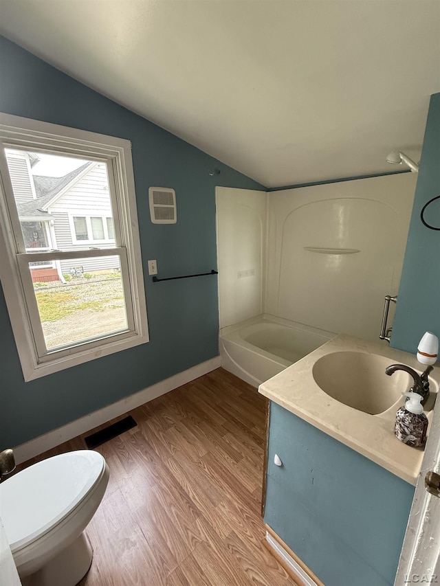 212 W Union St, Morenci, MI 49256 - bathroom with vaulted ceiling, toilet, wood finished floors, vanity, and baseboards