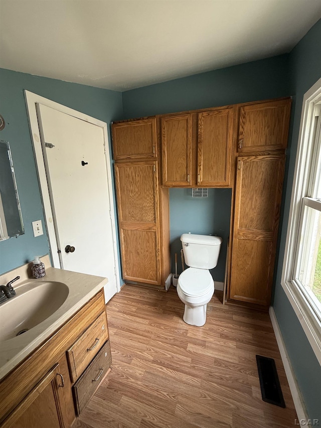 212 W Union St, Morenci, MI 49256 - bathroom with toilet, vanity, wood finished floors, and baseboards