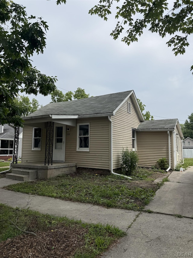 212 W Union St, Morenci, MI 49256 - view of front facade featuring covered porch and a shingled roof