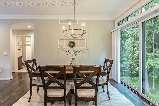 10327 9 Mile Rd, Whitmore Lake, MI 48189 - dining area with dark wood-type flooring, a chandelier, and ornamental molding