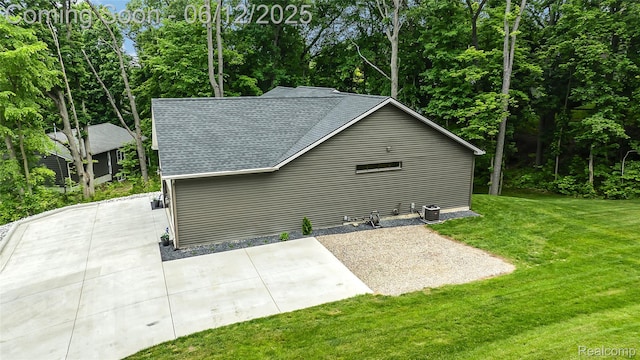 10327 9 Mile Rd, Whitmore Lake, MI 48189 - view of property exterior with roof with shingles, a yard, and a patio area