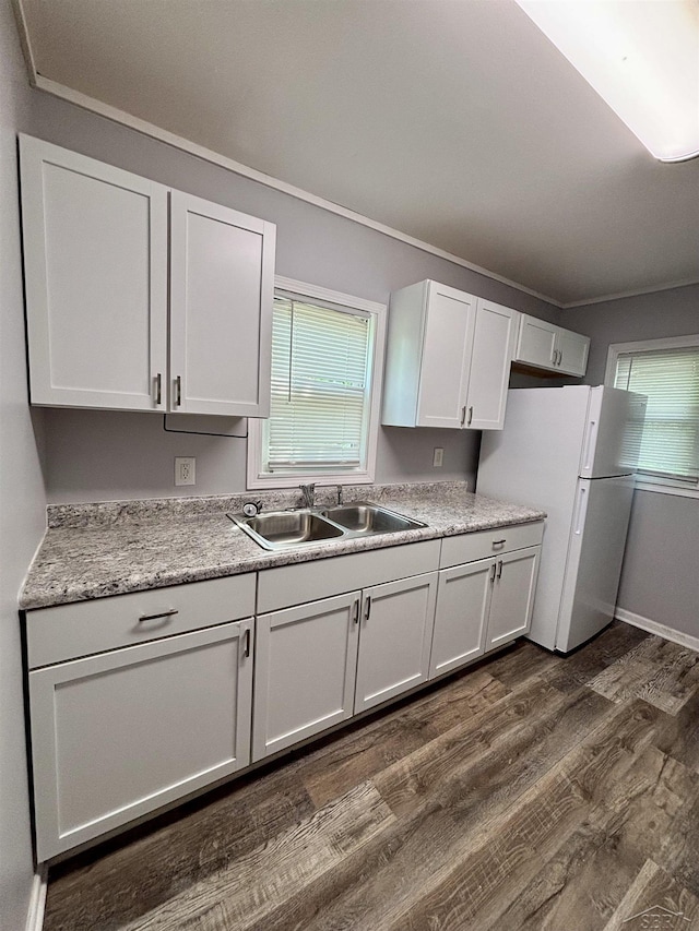 2138 N Clinton St, Saginaw, MI 48602 - kitchen featuring freestanding refrigerator, a sink, dark wood-type flooring, white cabinets, and crown molding