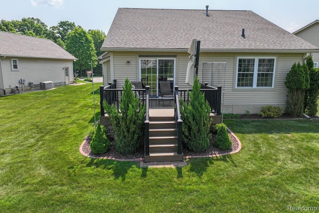 11118 Strathmore Ct, Grand Blanc, MI 48439 - rear view of house with roof with shingles, a lawn, a deck, and central AC