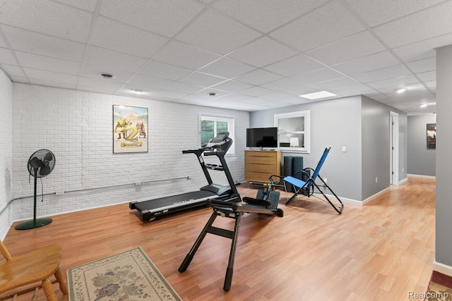 11118 Strathmore Ct, Grand Blanc, MI 48439 - exercise area with a drop ceiling, wood finished floors, brick wall, and baseboards
