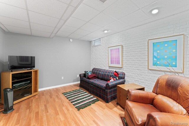 11118 Strathmore Ct, Grand Blanc, MI 48439 - living room with brick wall, baseboards, wood finished floors, a drop ceiling, and recessed lighting
