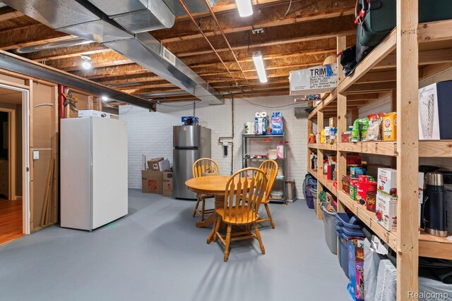 11118 Strathmore Ct, Grand Blanc, MI 48439 - unfinished basement featuring freestanding refrigerator and brick wall