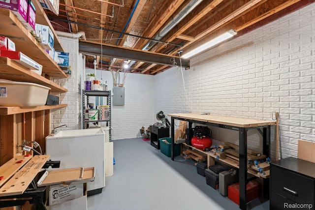 11118 Strathmore Ct, Grand Blanc, MI 48439 - unfinished basement with a workshop area, electric panel, and brick wall