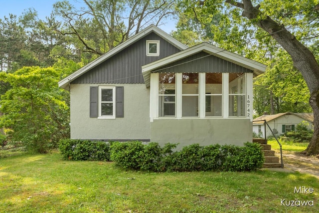 16742 148th Ave, Spring Lake, MI 49456 - view of property exterior with a lawn and stucco siding
